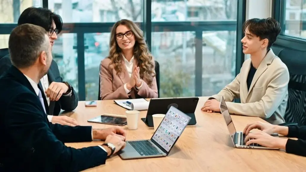 A consultant and client side-by-side at a laptop